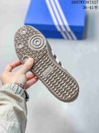 Close-up of the textured gum-colored outsole with geometric tread and adidas branding.