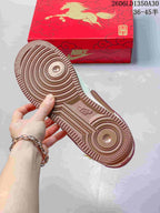 Close-up of the brown outsole and themed red shoe box