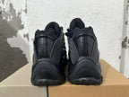 Rear view of black Nike Air Max SNDR sneakers showing heel branding and sculpted heel panels.