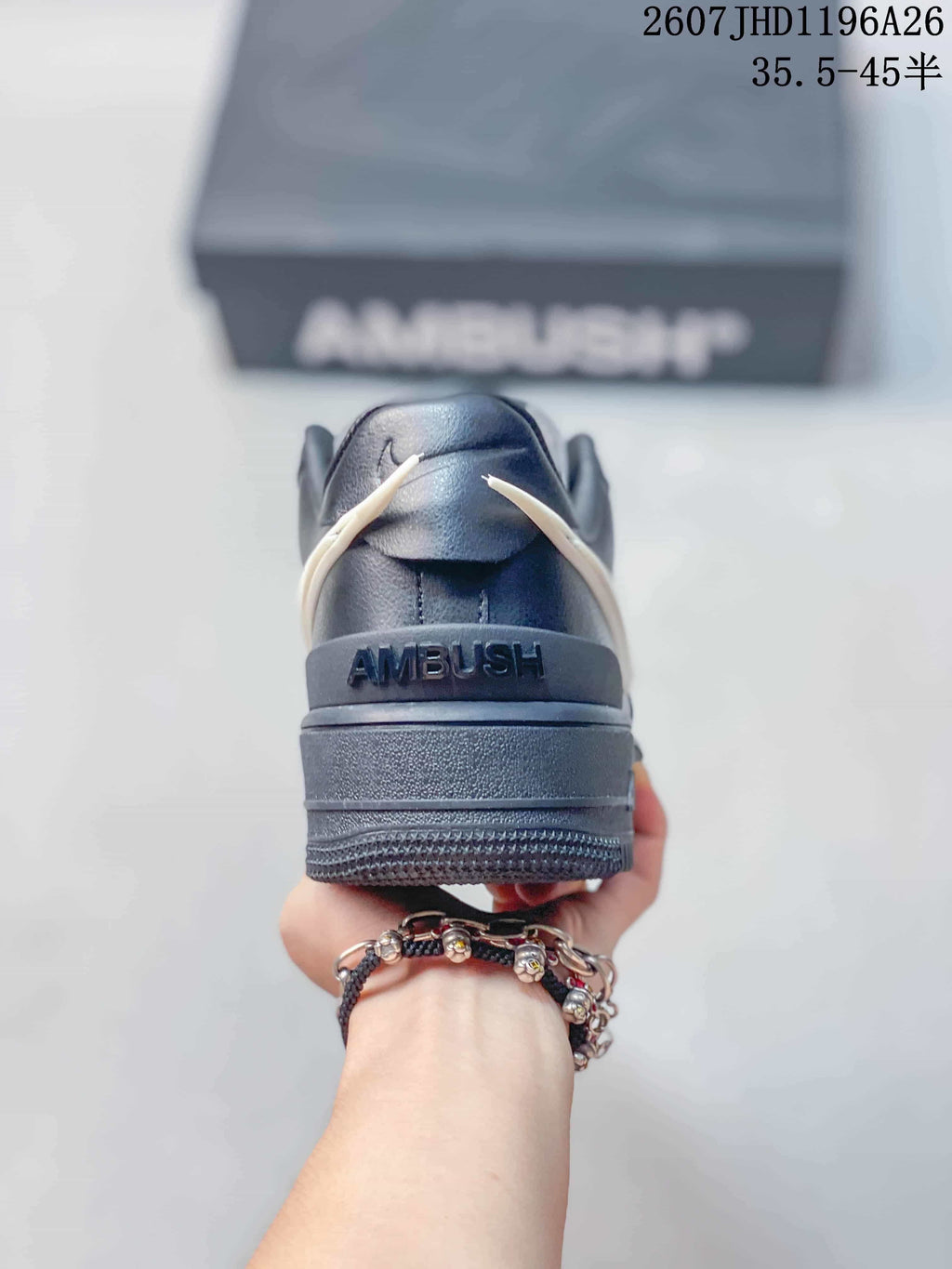 Rear view showing the black heel counter and visible Ambush branding.