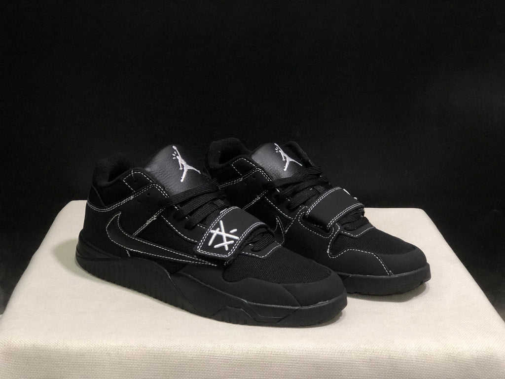 Three-quarter view of the pair highlighting the black colorway, layered panels and strap construction.