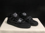 Three-quarter view of the pair highlighting the black colorway, layered panels and strap construction.