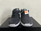 Front view of black lace-up basketball shoes with white midsoles