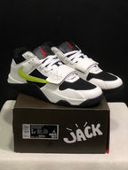 Pair of white, black, and fluorescent green Jumpman Jack TR sneakers displayed on the branded shoe box.
