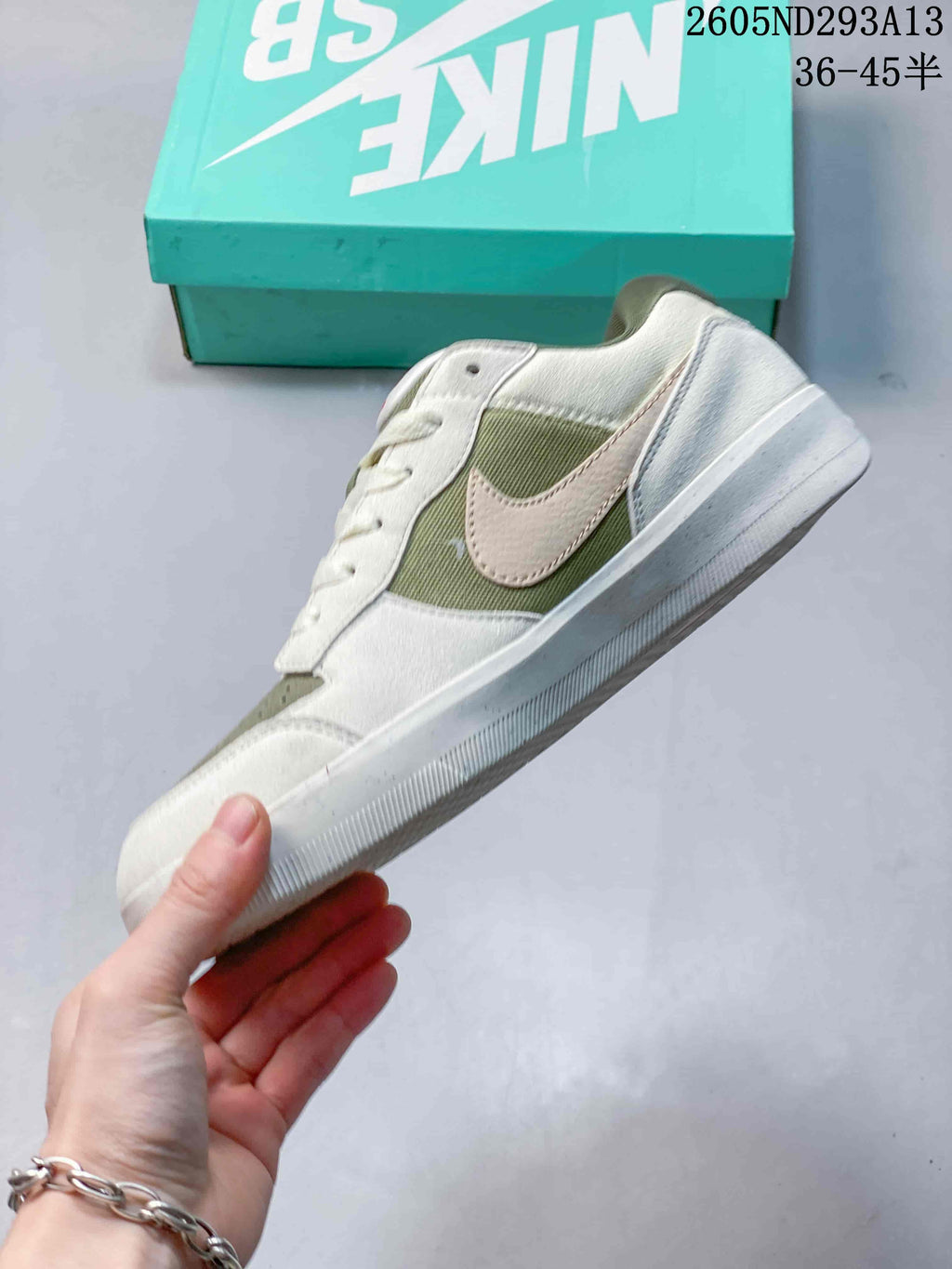 Side profile showing the low-top shape, contrasting side branding, layered upper panels, and rubber outsole.