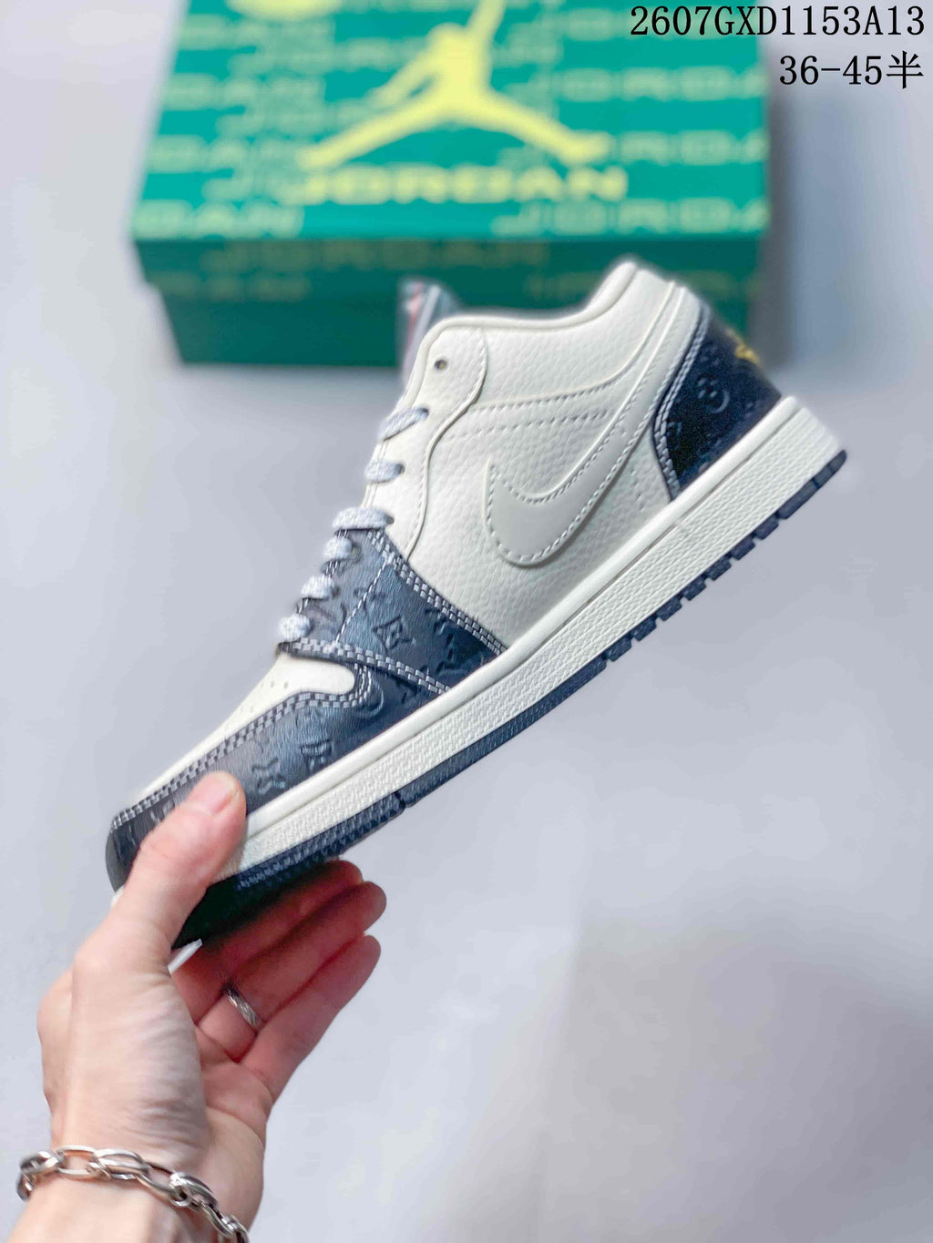 Side profile showing the white upper, layered overlays, patterned forefoot panel, and dark outsole.