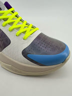 Close-up of the blue toe accent, perforations, and neon yellow laces