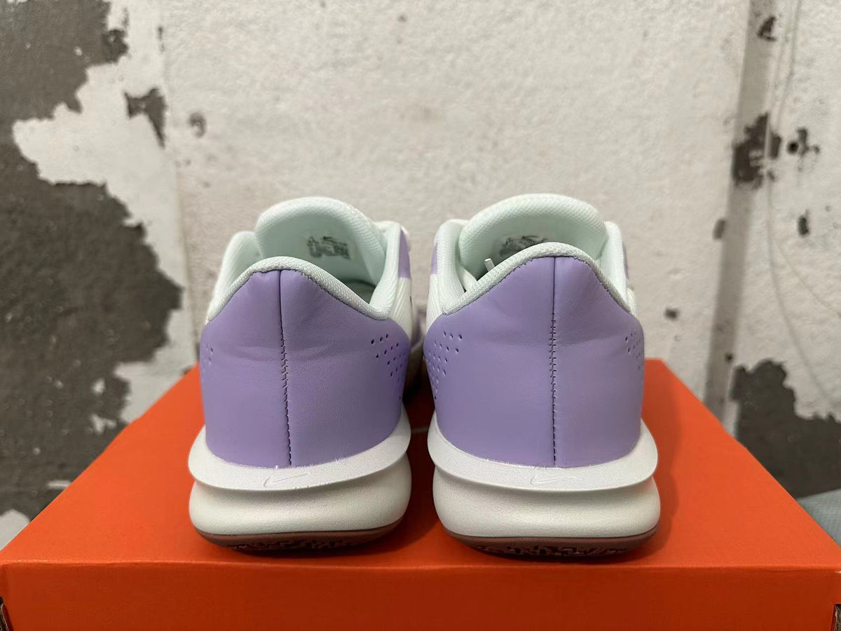 Rear view of white and light purple Nike Precision 7 basketball shoes