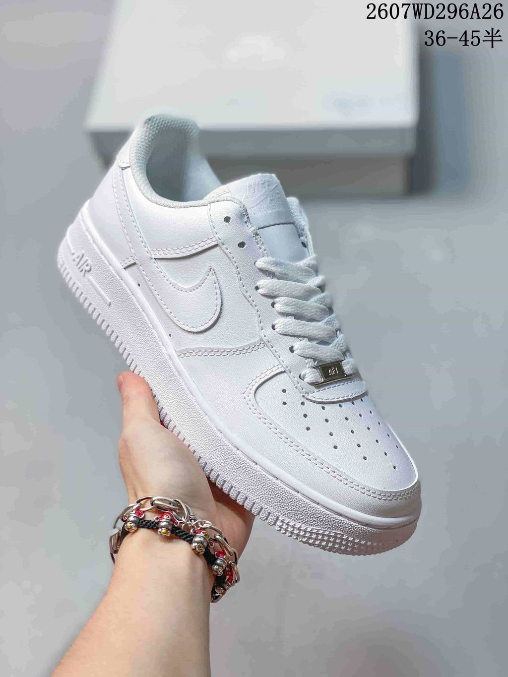 Close-up side view of a white low-top sneaker showing the swoosh, perforated toe, lace-up front and textured outsole.