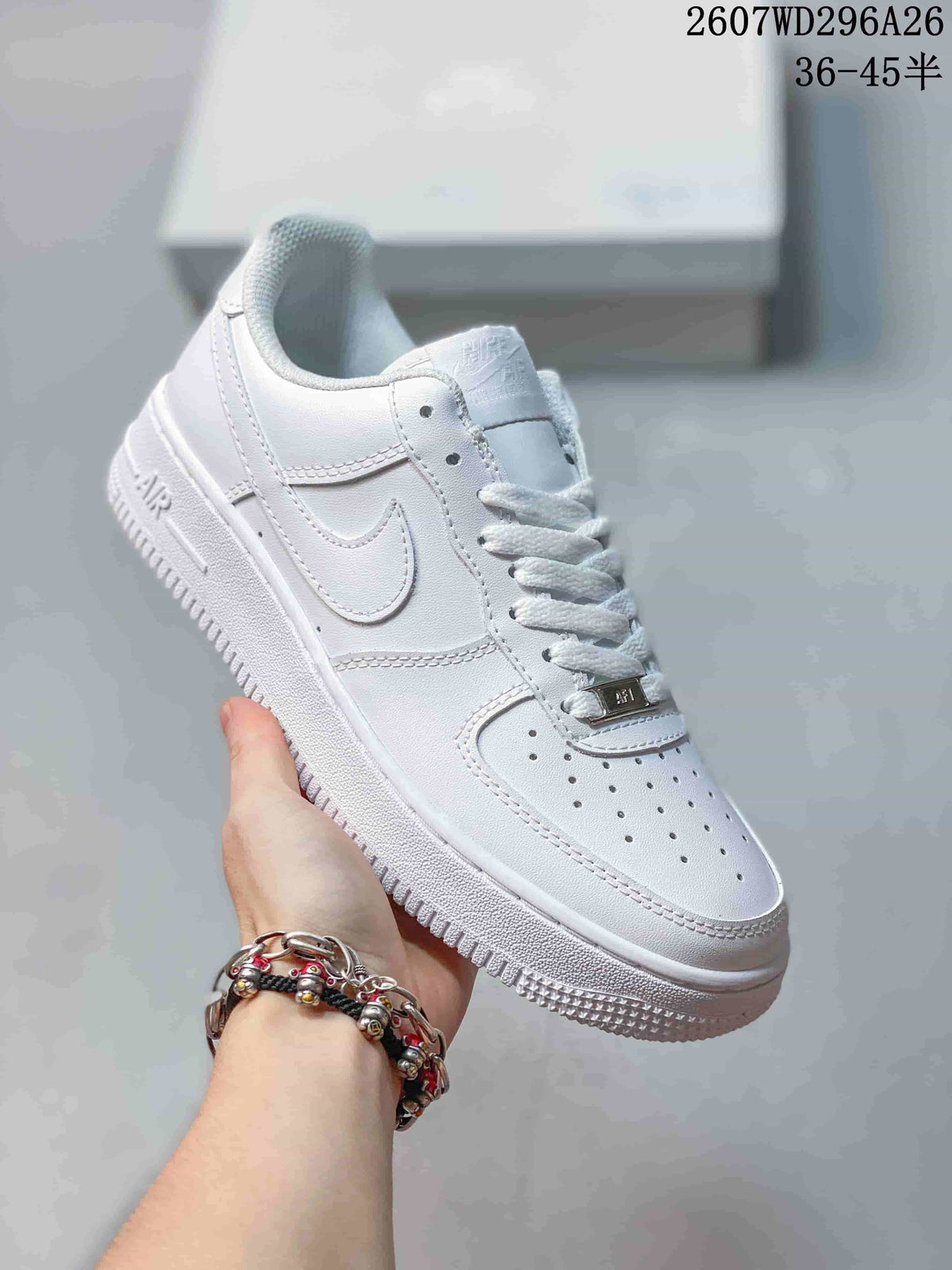 Close-up side view of a white low-top sneaker showing the swoosh, perforated toe, lace-up front and textured outsole.