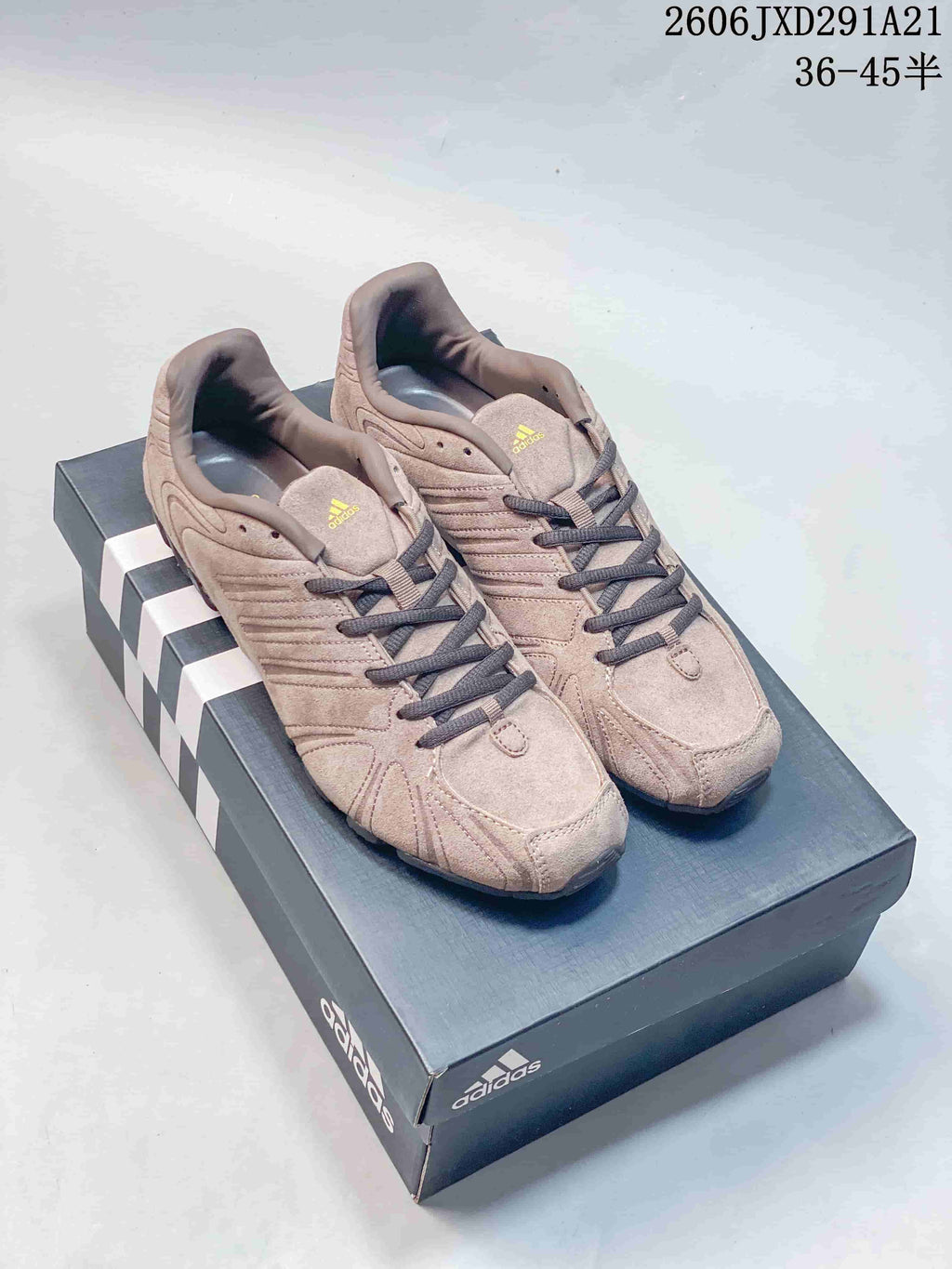Pair of beige-taupe adidas Originals Ghost Sprint sneakers displayed on an adidas shoebox.