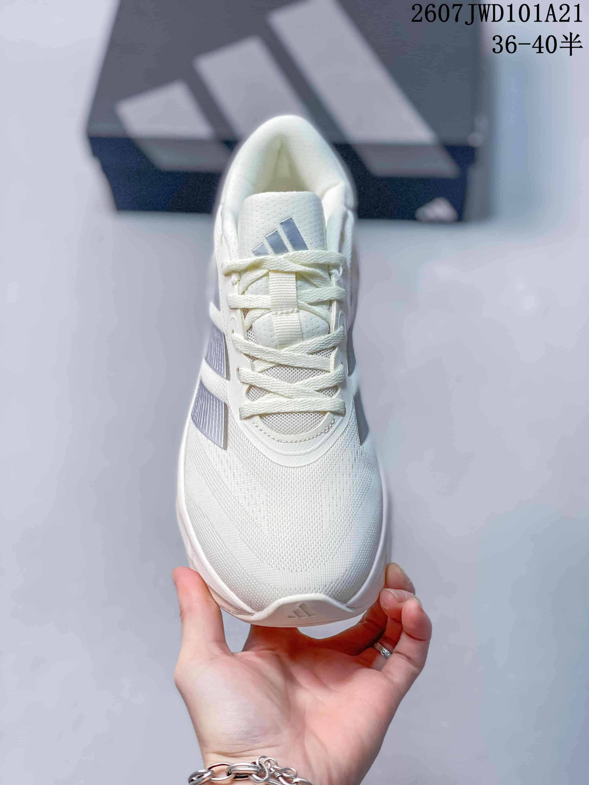 Top view of the white lace-up sneaker showing the perforated-looking tongue, laces, toe box and Adidas tongue logo.