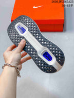 Underside of a Nike Vomero Premium shoe showing a black patterned outsole and blue-colored sections.