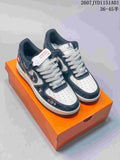 White and navy low-top sneakers with patterned side panels and thick laces