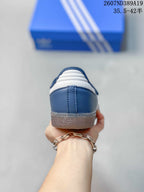 Rear view of the blue sneaker showing the white heel accent, stitching, and translucent outsole.