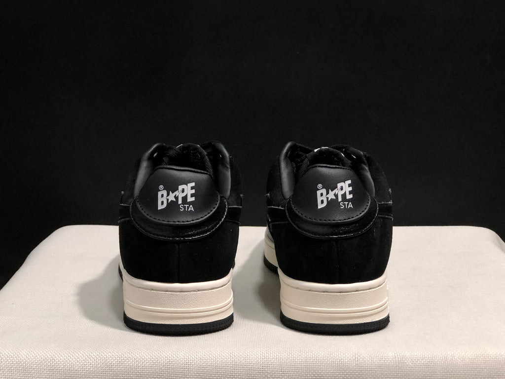 Rear view showing paired sneakers with Bape Sta branding on the heel tabs.