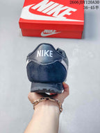 Rear view of a dark Nike Classic Cortez sneaker with heel branding