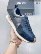 Close side view of a navy ECCO sneaker showing its contrasting panels and layered sole.