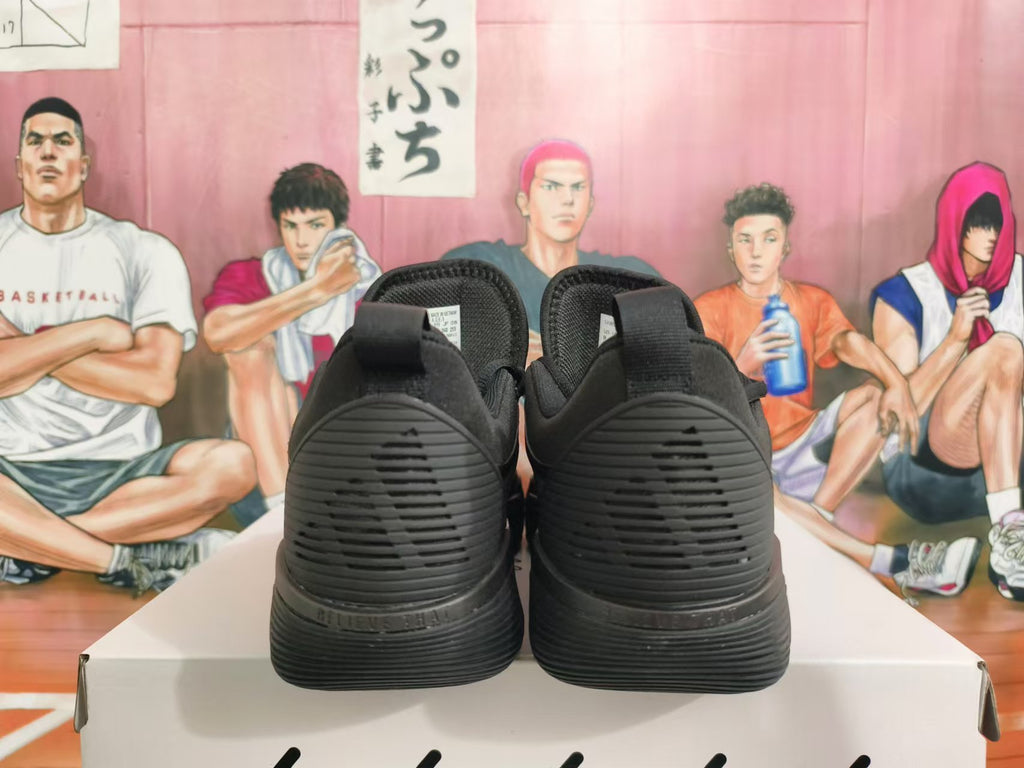 Rear view of all-black Nike basketball shoes showing the heel and outsole details