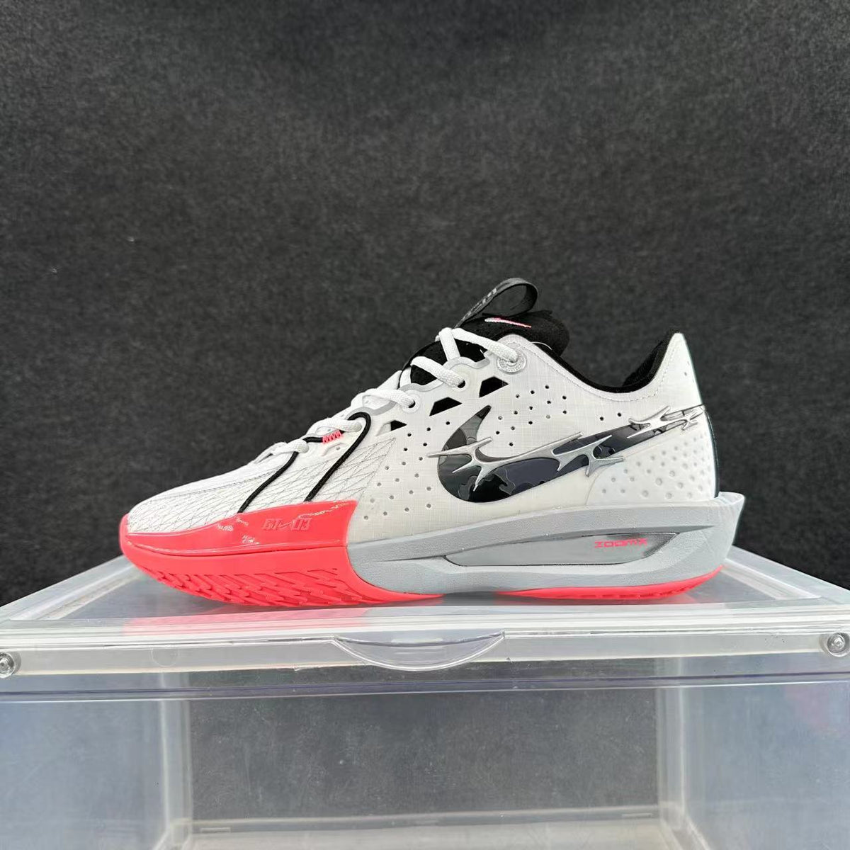 White, black, and bright pink Nike GT Cut 3 basketball shoe shown from the side