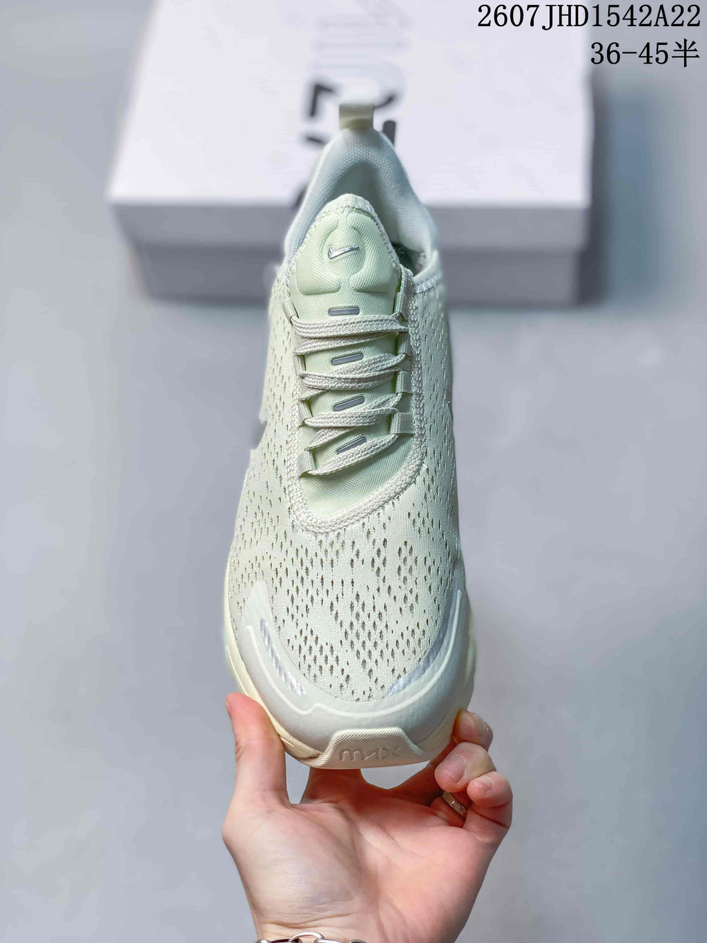 Front view of the pale mint green sneaker showing the perforated toe box and laces.