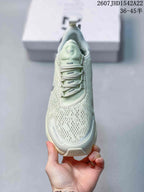 Front view of the pale mint green sneaker showing the perforated toe box and laces.