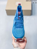 Front view showing the rounded toe, blue upper, cord laces and toggle closure.