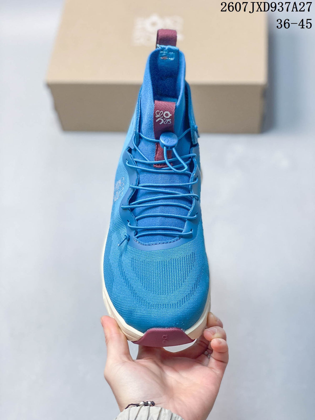 Front view showing the rounded toe, blue upper, cord laces and toggle closure.
