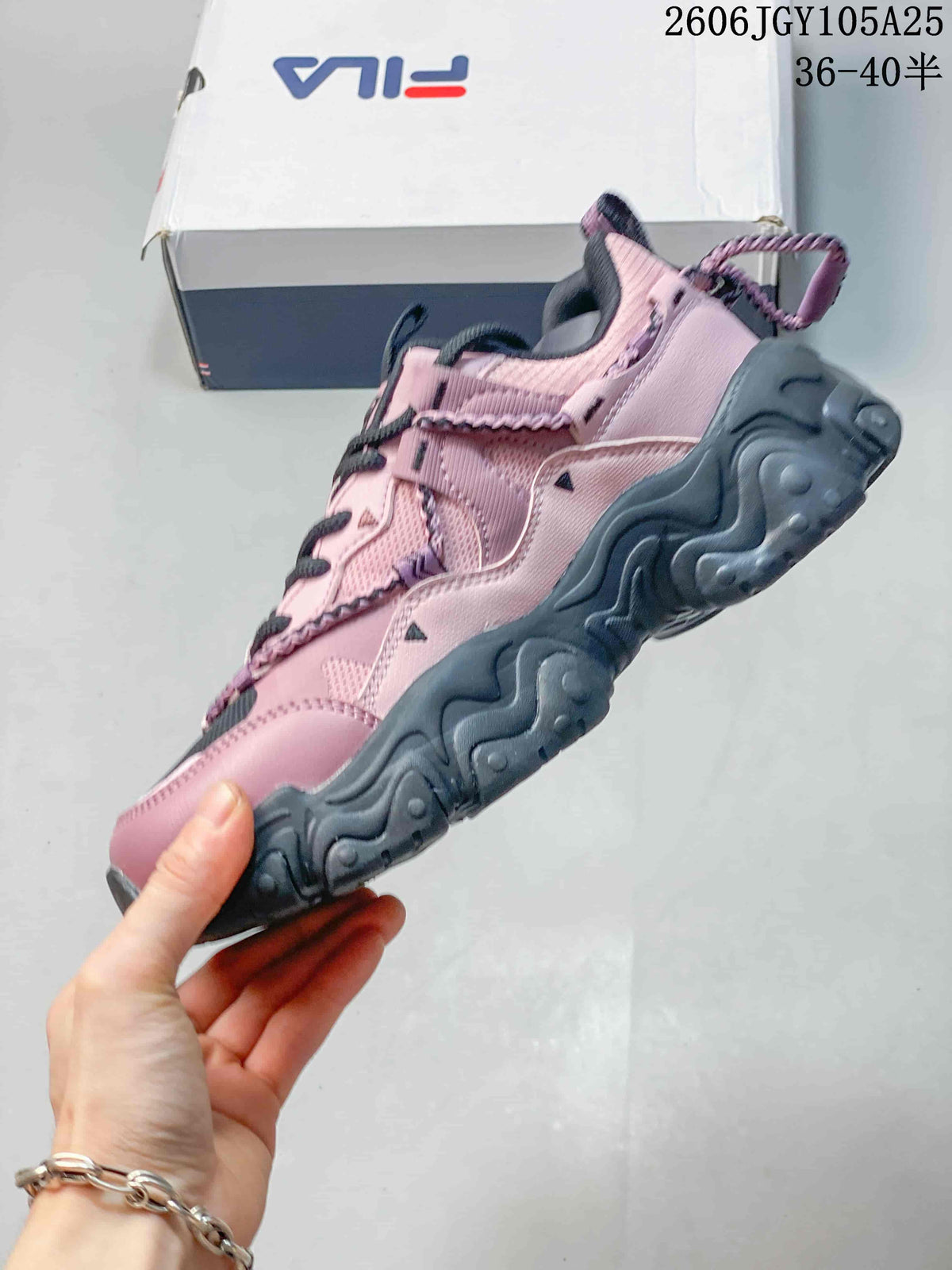 Side profile of the pink and charcoal FILA Fusion sneaker with a chunky sole.