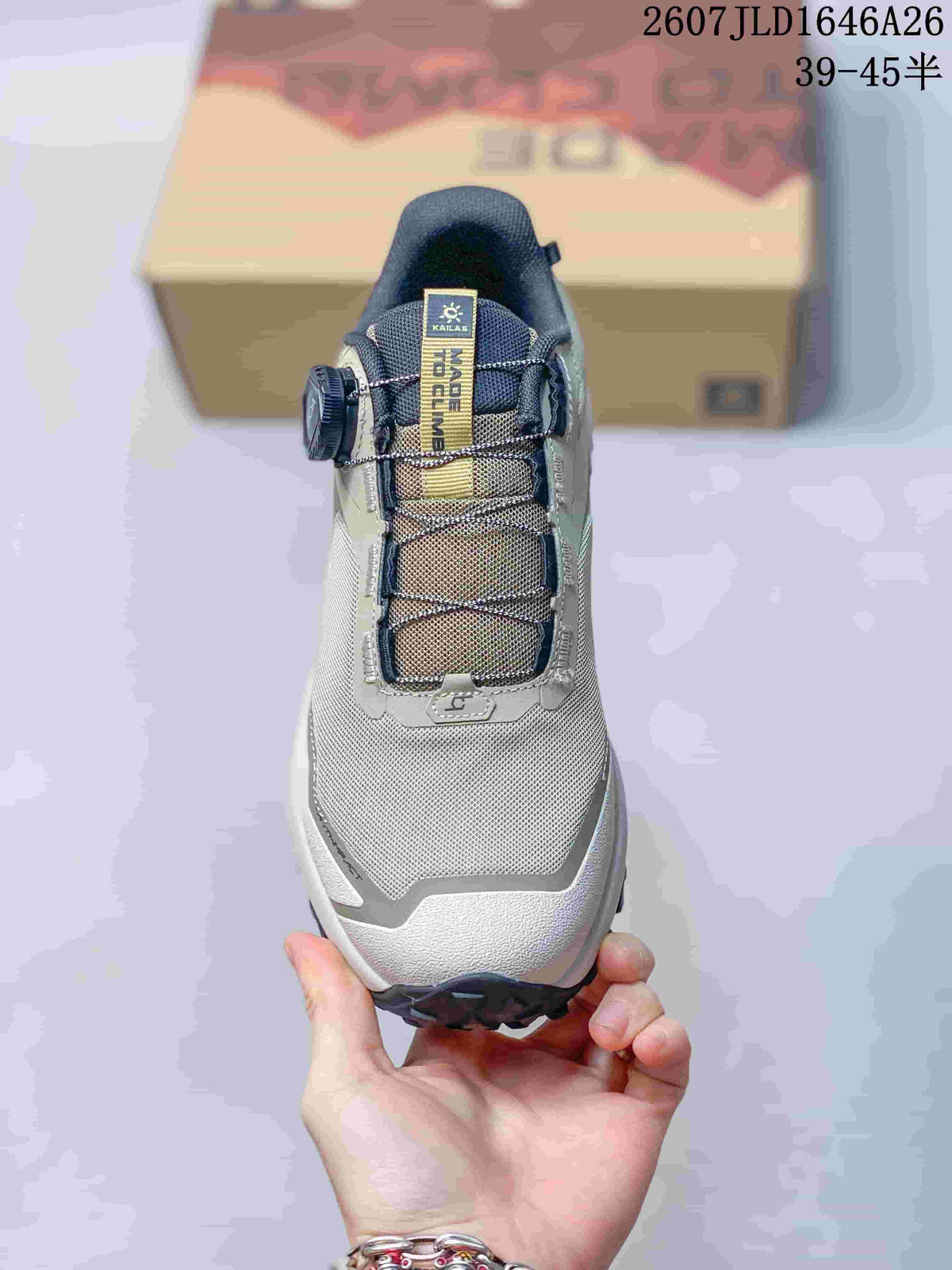 Front view of the shoe showing the gray toe area, dark tongue, mesh-like upper, lace structure, and BOA dial closure.