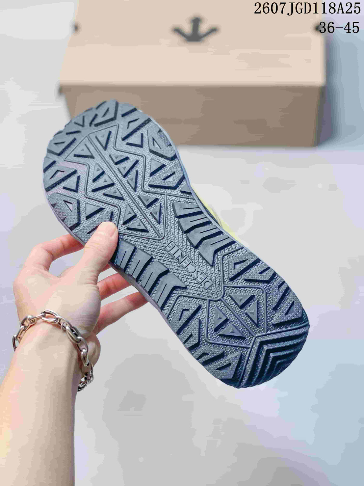 Close-up of the sneaker outsole showing a deep geometric tread pattern.