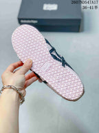 Close view of the pale pink textured outsole with repeating tread and molded branding.
