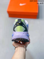 Rear view of the sneaker showing the black heel detail, green heel panel, and sculpted midsole.