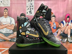 Pair of black patterned high-top basketball shoes with gold side logos and green outsoles