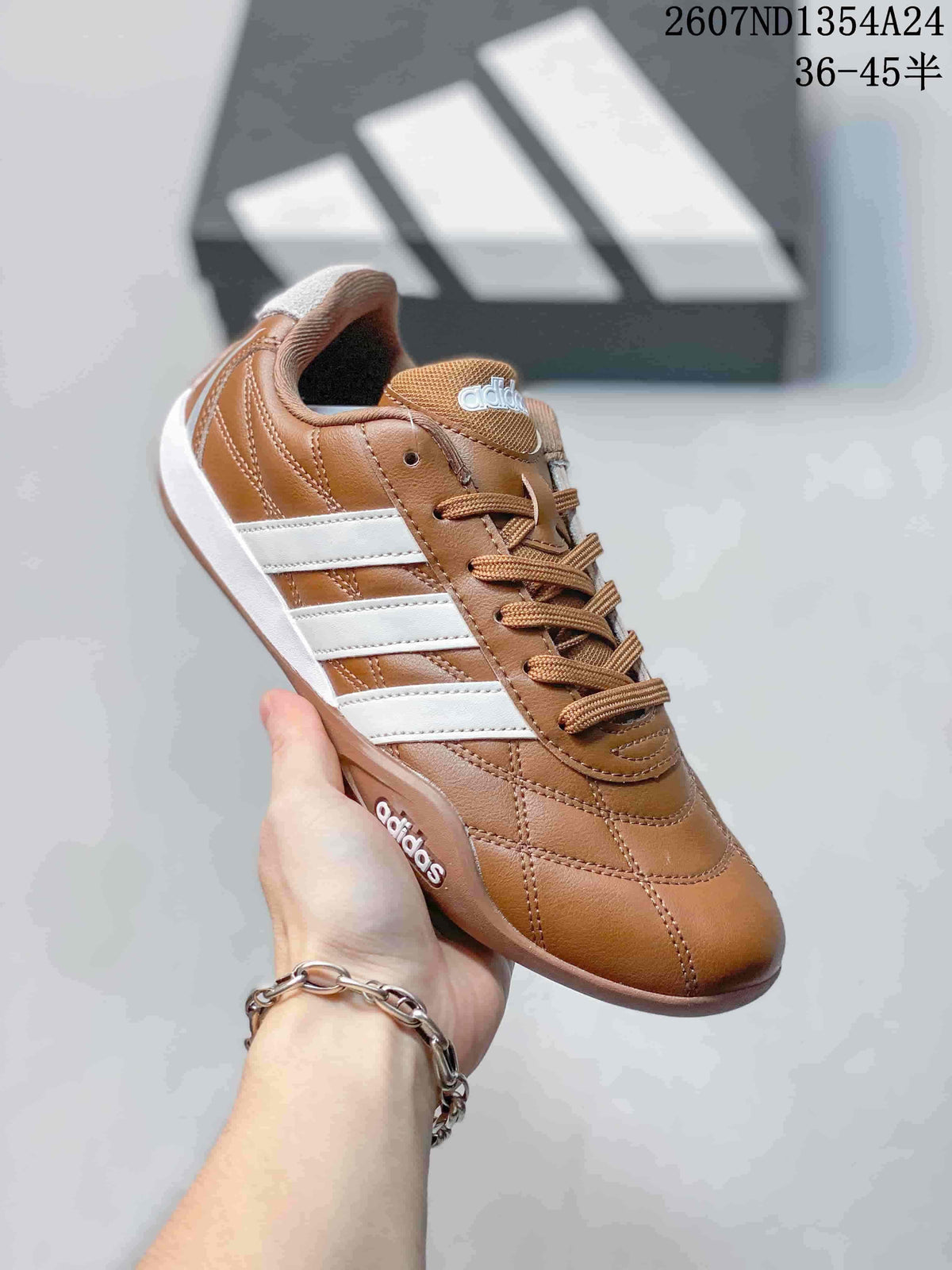 Brown and white adidas Adipista low-top sneaker shown at an angle with matching brown laces and stitched panels.