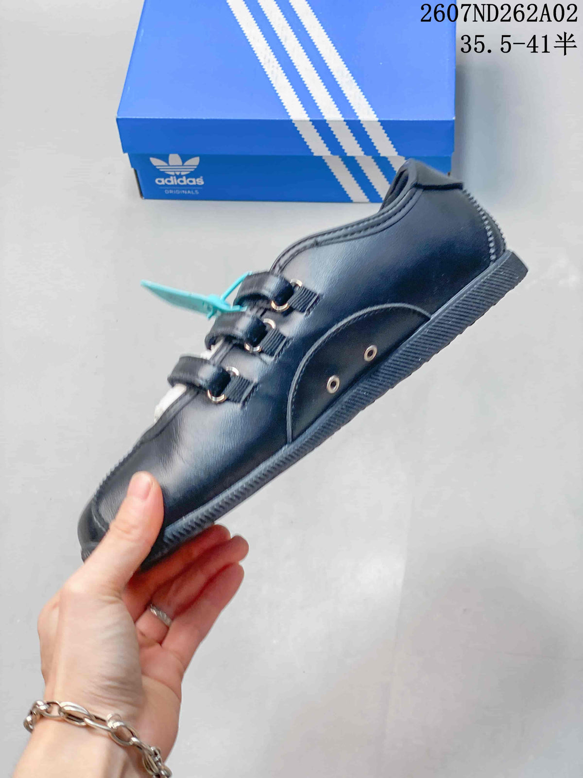 Side view of the black adidas Originals ANFU MJ sneaker with three straps and contrasting stripes