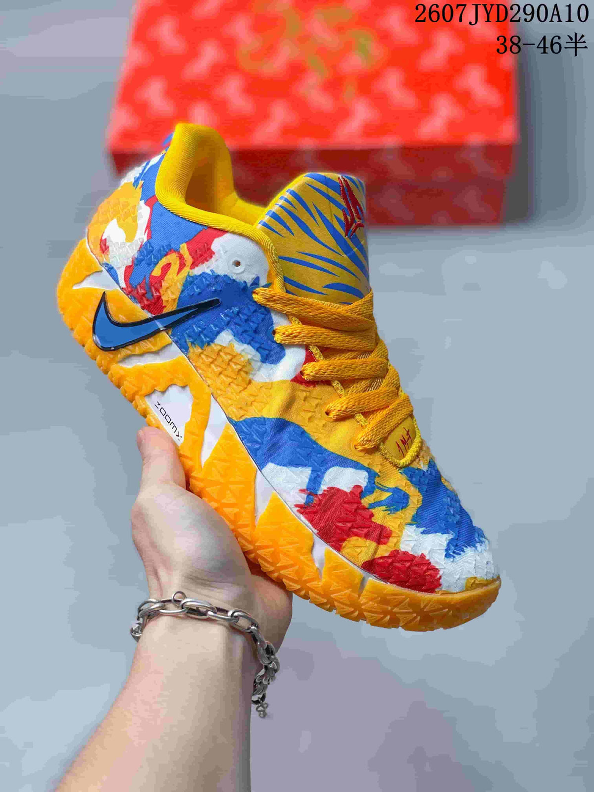 Blue, yellow, red, and white Nike Ja 3 shoe with multicolor graphics, yellow laces, and an orange outsole.