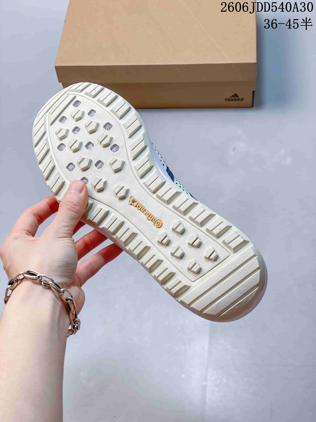 Close-up of the textured outsole with raised tread blocks on a blue Terrex sneaker.