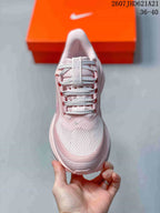 Top view showing the pink mesh-look toe box, laces and tongue branding.