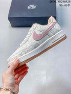 Side view of the low-top sneaker with pink Swoosh and gum-colored outsole