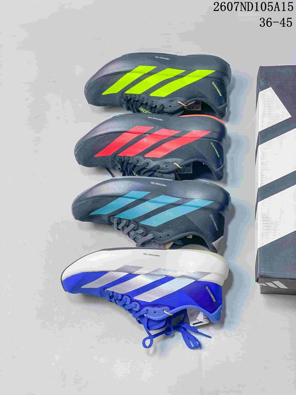 Four pictured Adidas Adizero colorways arranged beside a shoebox: bright green, red, teal, and blue with white.