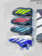 Four pictured Adidas Adizero colorways arranged beside a shoebox: bright green, red, teal, and blue with white.