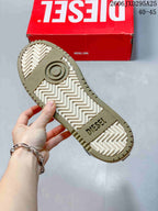 Underside of the sneaker showing a patterned white and khaki-colored sole