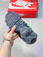 Close-up of the textured outsole of a black and green sneaker