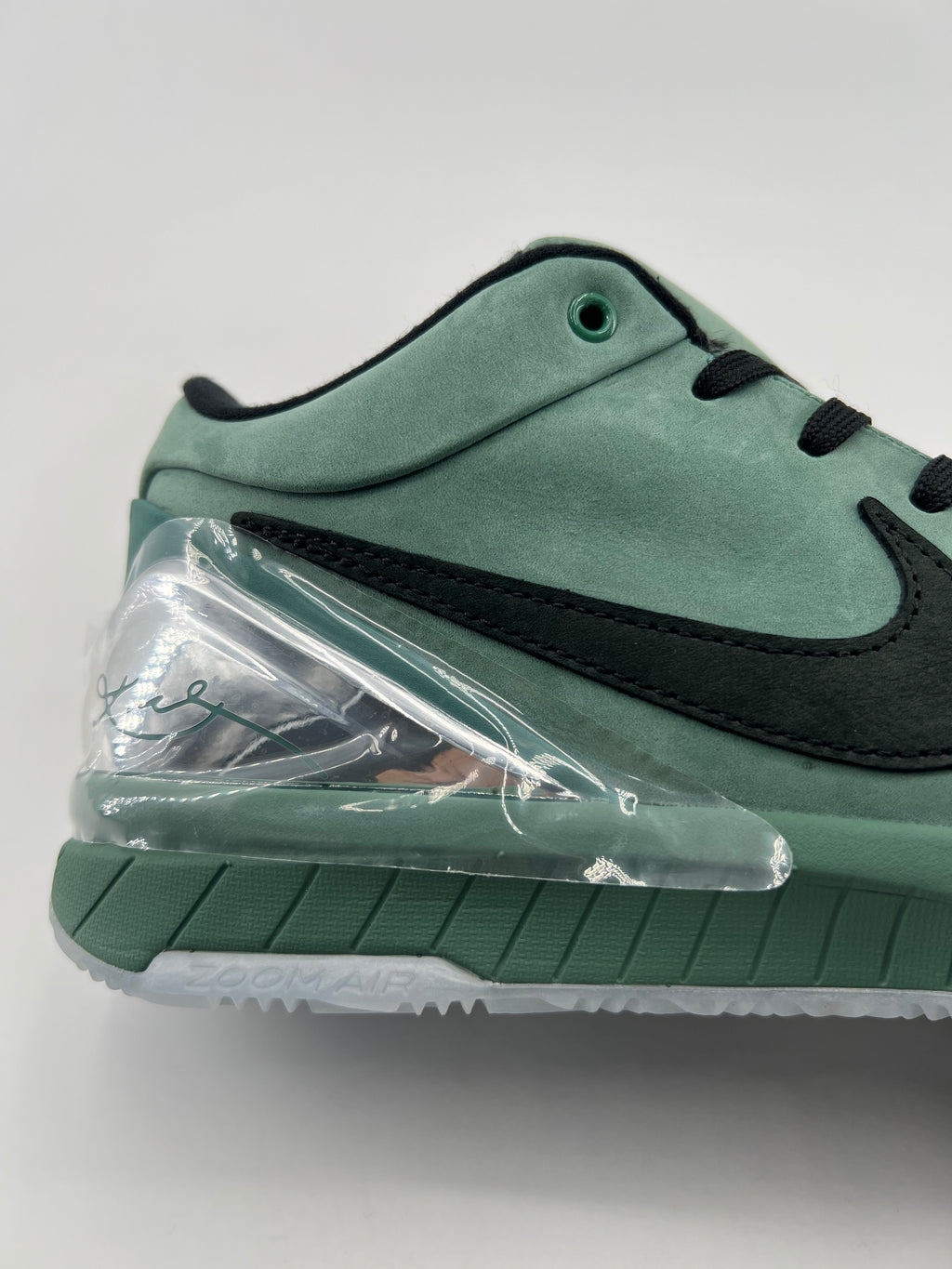 Close-up of the green heel and clear heel accent above the outsole