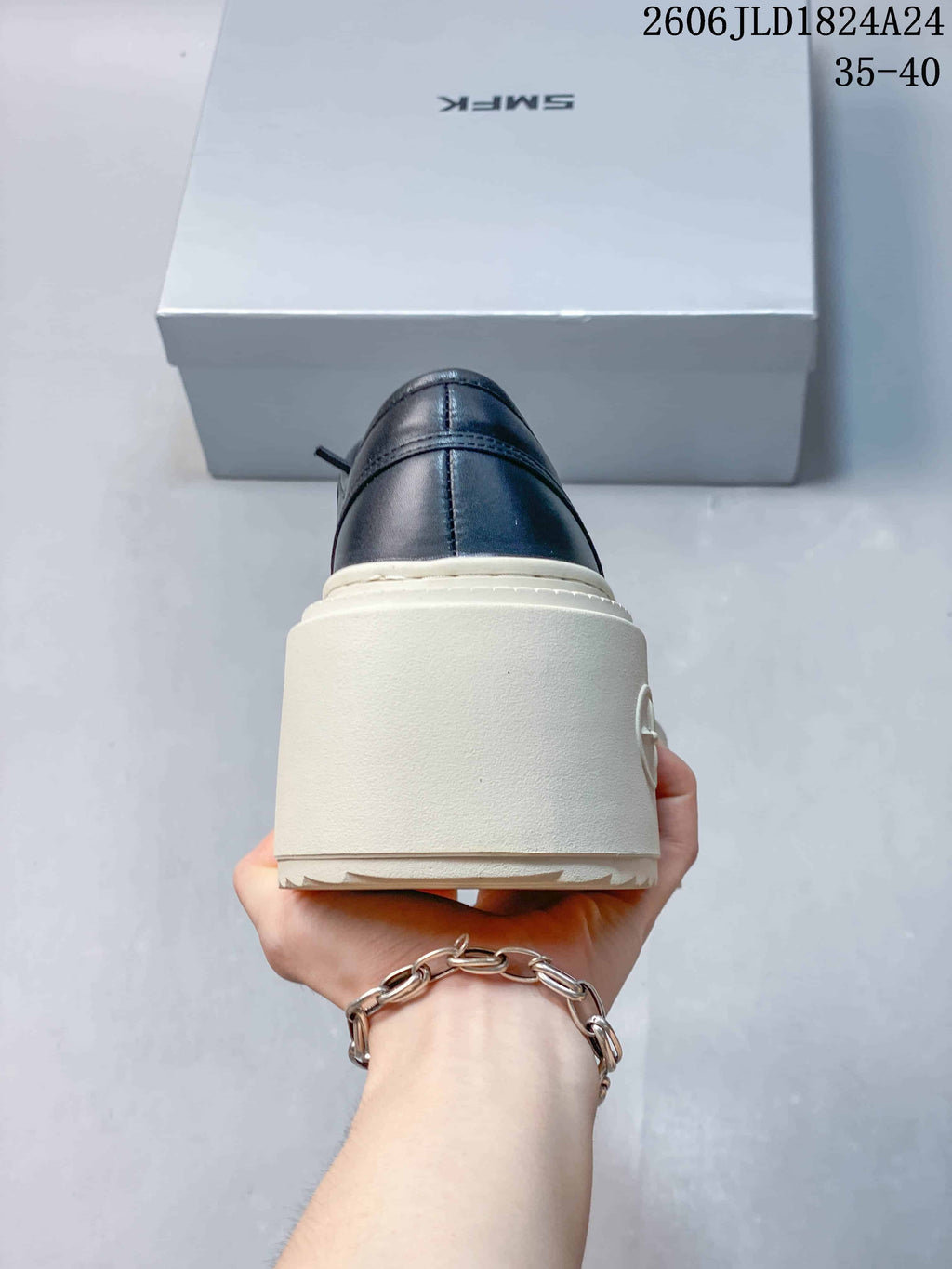 Rear view showing the dark heel and thick ivory platform sole