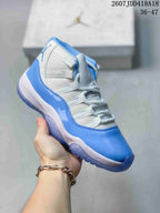 Close-up side view of a white and blue high-top sneaker showing the glossy overlay, mesh-like panels and translucent-looking outsole.