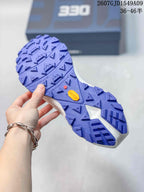 Close-up of the purple lugged outsole showing deep multidirectional tread and visible Vibram branding.