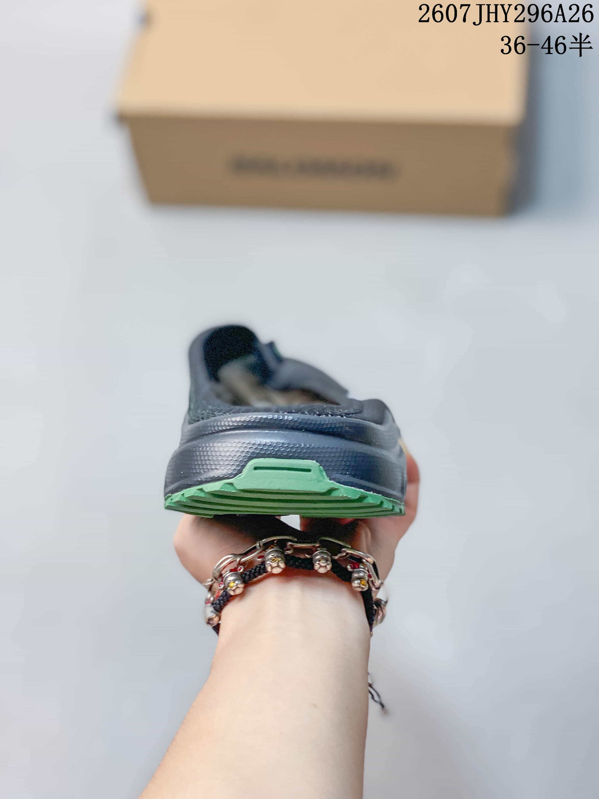 Rear view highlighting the raised heel structure and green outsole accent.