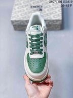 Top view showing green laces, perforated green toe panel, white overlays, and tongue branding.